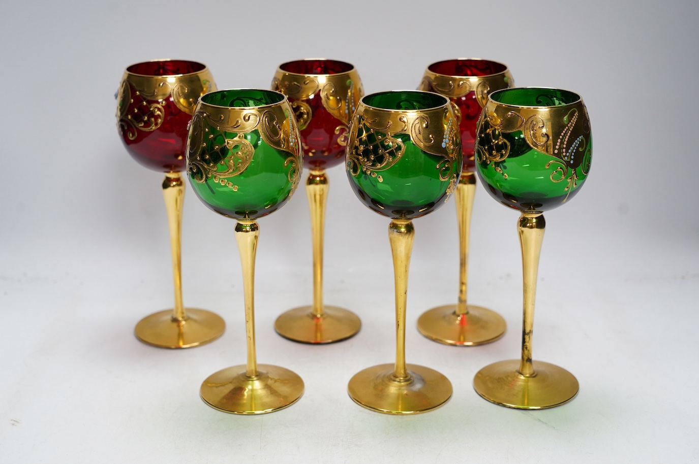 A set of six Venetian gilt and enamelled wine glasses, 21cm. Condition - good